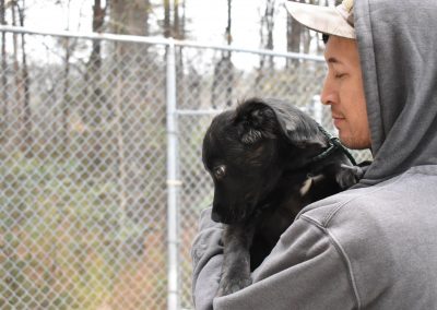 Puppy held by trainer at Smith Farms Kennel, the best kennel in Conyers, Georgia